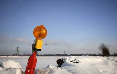 Red lamp from road block in snow