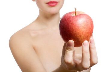 beautiful young blonde woman offering red apple, Focus on apple