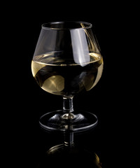 one glass white wine on black background