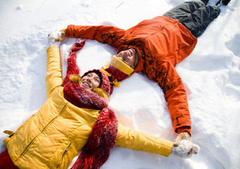 The young family plays winter wood on snow