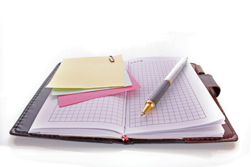 Open notebook with a pen on white
