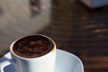 Real turkish coffee in a small white porcelain cup