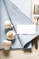 fork and mushrooms on blue napkin