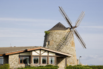 Plakat image of a windmill building over a blue sky