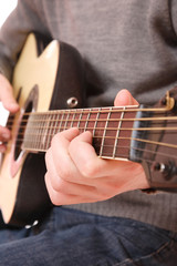 Fototapeta na wymiar Close up of guitarist hand playing guitar