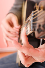 Fototapeta premium Close up of guitarist hand playing guitar