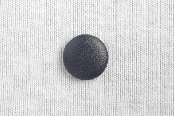 Blue button at the center on white cloth