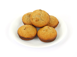 Fresh baked bran muffins on white plate