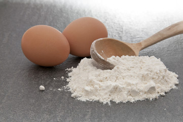 Eggs with flour and wooden spoon