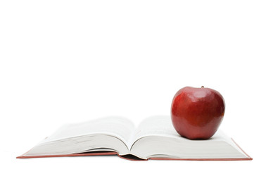 Red apple on the open book