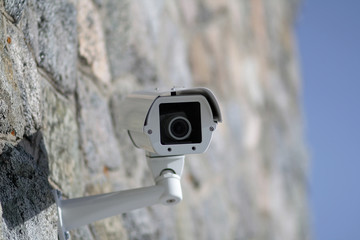 Surveillance camera mounted on a wall outside the building