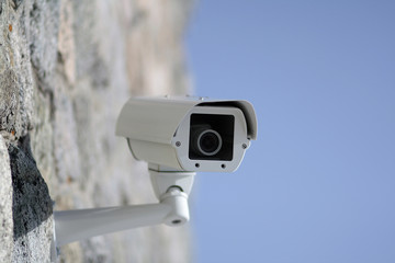 Surveillance camera mounted on a wall outside the building
