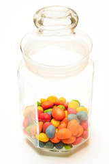A glass jar with colored candies