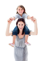 Pretty mother giving her daughter piggyback ride