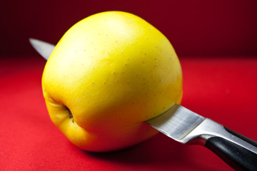 Knife slicing an apple