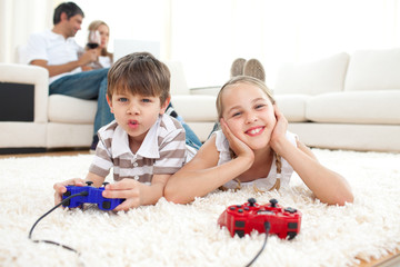 Obraz na płótnie Canvas Adorable siblings playing video games