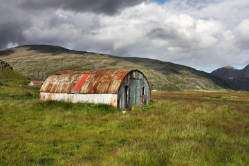 Iceland - green pastures and farm warehouse