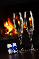 glasses with champagne and a gift