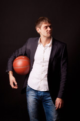 happy successful businessman holding basketball ball