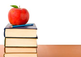 Books and apple isolated on white background