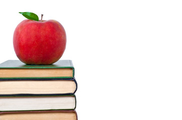 Books tower with apple isolated on white