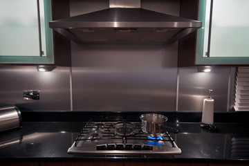 Stainless steel pan on gas hob in a modern kitchen