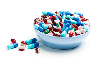 Bowl of multicolored pills, tablets, and capsules