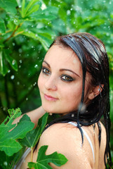 The wet girl on back background trees