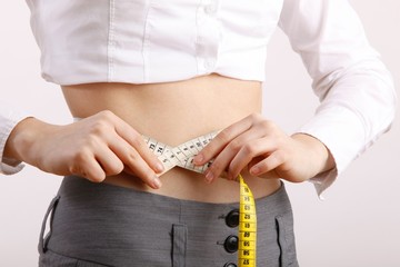 woman with measuring tape around her body
