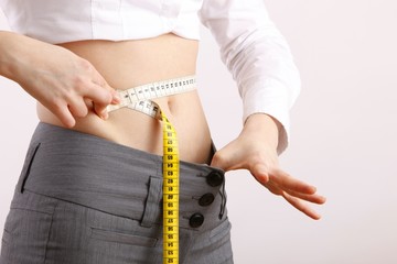 woman with measuring tape around her body