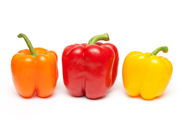 peppers in a row on white background