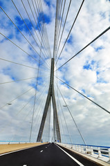 cable-stayed bridge in the background of blue sky with clouds