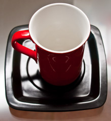 Red cup on the black plate