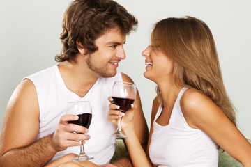 Cheerful young couple drinking wine
