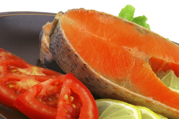 two salmon steak on dark dish