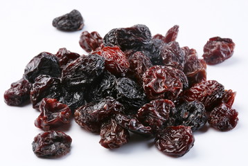 Black raisins on a white background