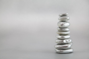 Balancing silver pebbles
