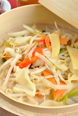 asian stir fry mix in a bamboo steamer