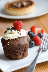 Chocolate muffin with cream and fruit