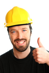 Thumbs up - young happy construction worker