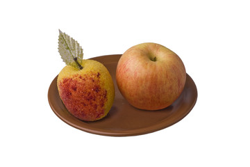 red yellow and artificial apples on brown plate