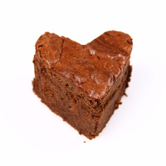 Heart shaped slice of a brownie on white background