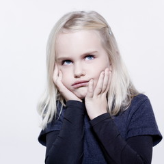 studio portrait of a caucasian cute sulk litle girl