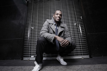 Man squatting in the dark