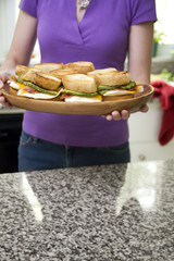 Woman Serving Egg Sandwiches