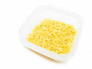 One side curled short-cut pasta in plastic container.