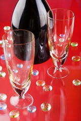 Glass of red wine with glass and bottle.