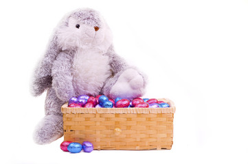 easter bunny with colorful eggs in basket