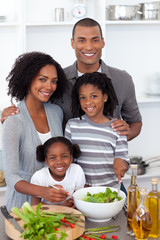 Ethnic family preparing salad together