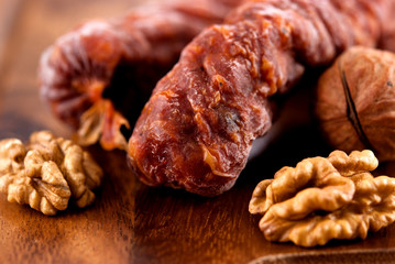 Close up of dry sausage and walnuts